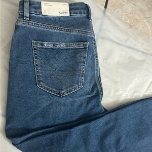 Curvy women’s blue ripped jeans